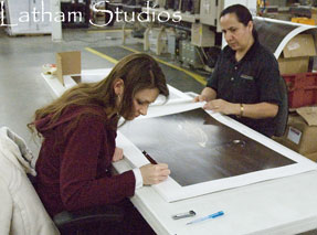 Autographing prints for Ducks Unlimited.........